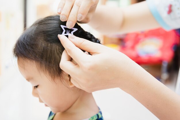 Asian Lady Weaving Braids Hair For Child Little At Home Photo