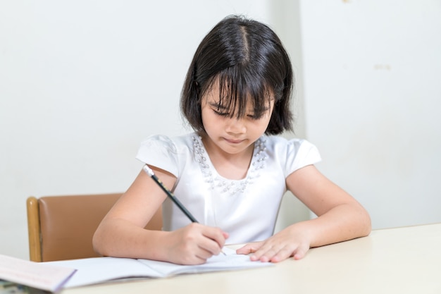 Premium Photo | Asian little girl children student writing on notebook ...