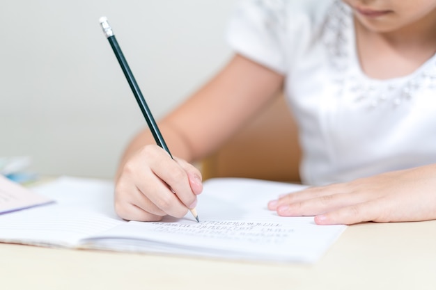 Premium Photo | Asian little girl children student writing on notebook ...