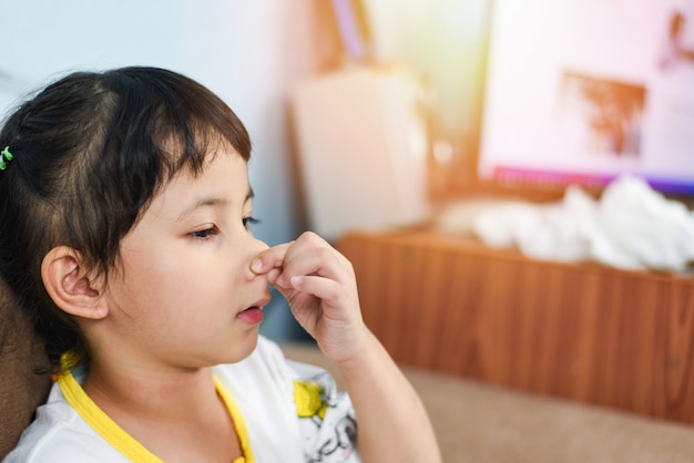 Premium Photo Asian Little Girl Sick With Hand Holding The Nose Get Cold And Blow Nose The Flu Season Child Runny Nose And Sneezing Blowing Their Nose And Fevers At Home