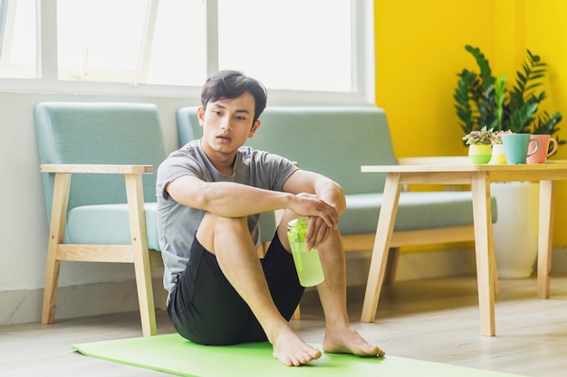 Premium Photo | Asian man sitting at rest after exercise