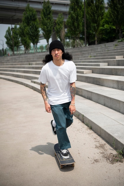 Premium Photo | Asian man skateboarding in the city