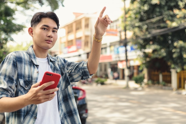 Premium Photo  Asian man waiting for uber taxi