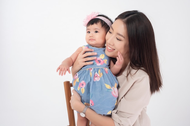 Premium Photo | Asian mother and adorable baby girl are happy on white wall