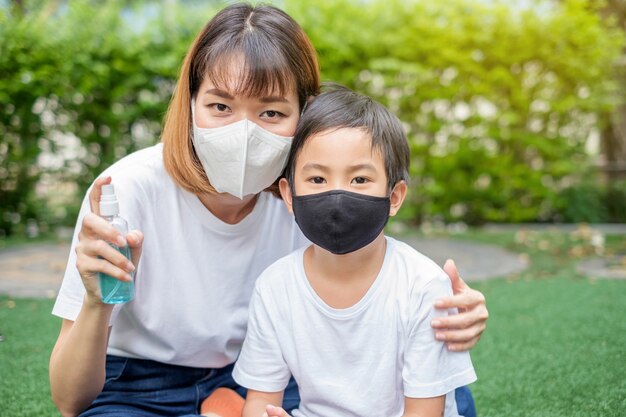 Premium Photo | Asian mother and her son wearing protective masks