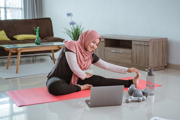 Premium Photo | Asian muslim woman doing exercise and sport at home