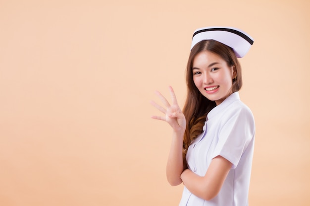 Premium Photo Asian Nurse Pointing Four Fingers Up