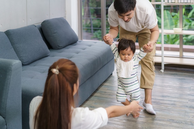 Premium Photo | Asian Son Baby Taking First Steps Walk Forward To His ...