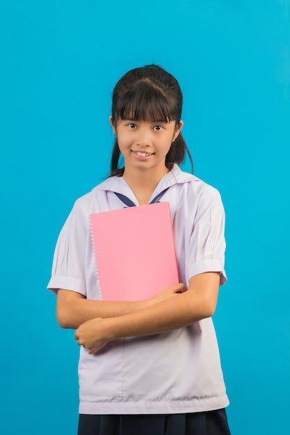 Asian Student With Long Hair Girl Holding A Notebook On