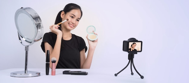 Premium Photo Asian Teen Woman Sit In Front Of Camera And Live Broadcasting As A Beauty Blogger Influencer Or Youtuber To Review Or Advice About How To Make Up At Home