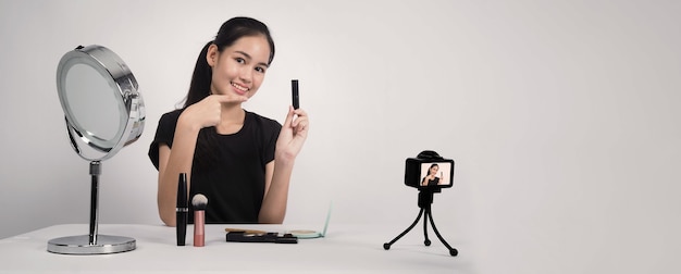 Premium Photo Asian Teen Woman Sit In Front Of Camera And Live Broadcasting As A Beauty Blogger Influencer Or Youtuber To Review Or Advice About How To Make Up At Home