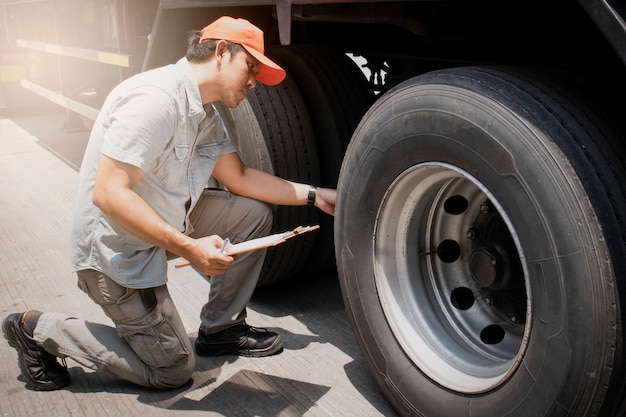 Premium Photo | Asian a truck driver holding clipboard inspecting ...