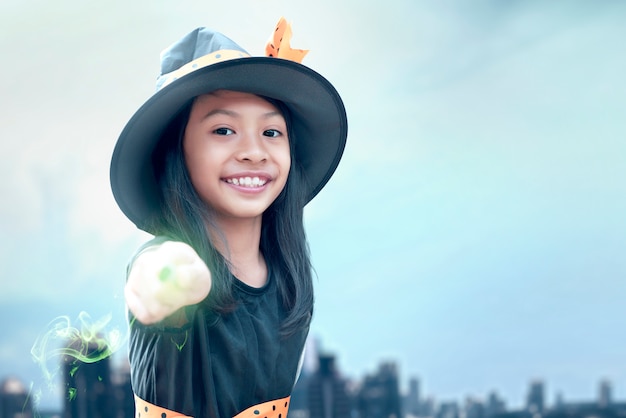 Premium Photo Asian Witch Little Girl Using The Wand With A Magic S