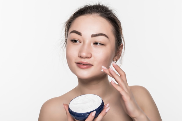 Asian woman applying cosmetic cream on facial skin care face on ...