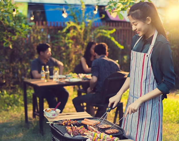 Asian woman are cooking for a group of friends to eat barbecue ...