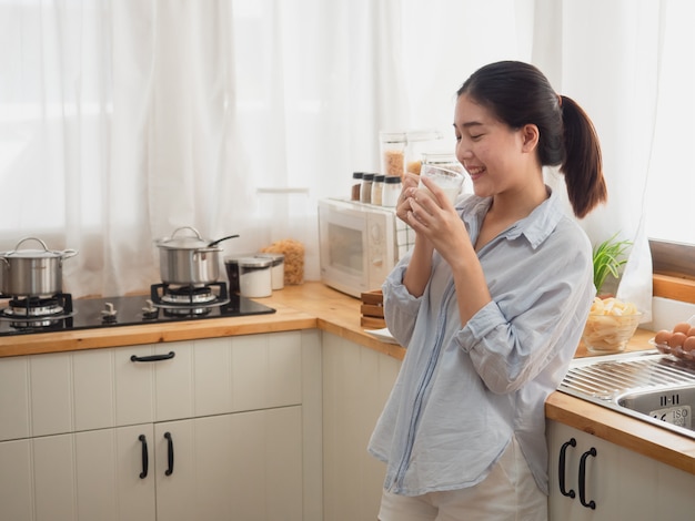 Premium Photo | Asian woman drink milk in the kitchen