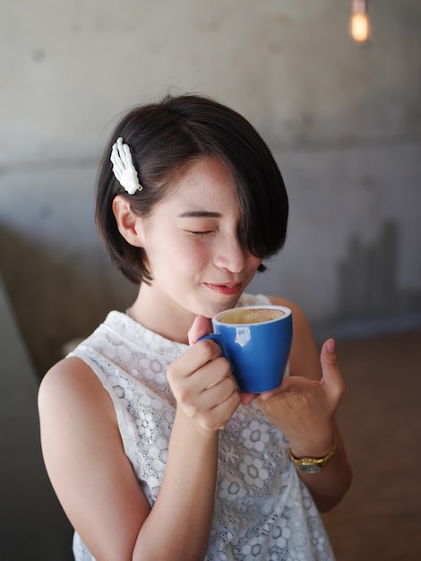 Premium Photo | Asian woman drinking coffee in cafe