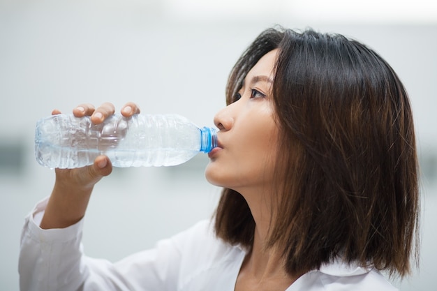 Free Photo | Asian woman drinking water from plastic bottle
