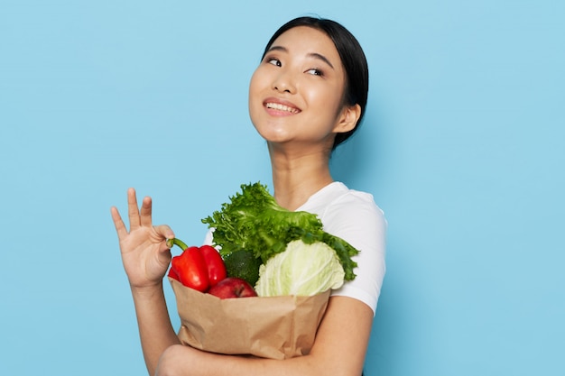 Premium Photo | Asian woman holding paper bag with vegetables