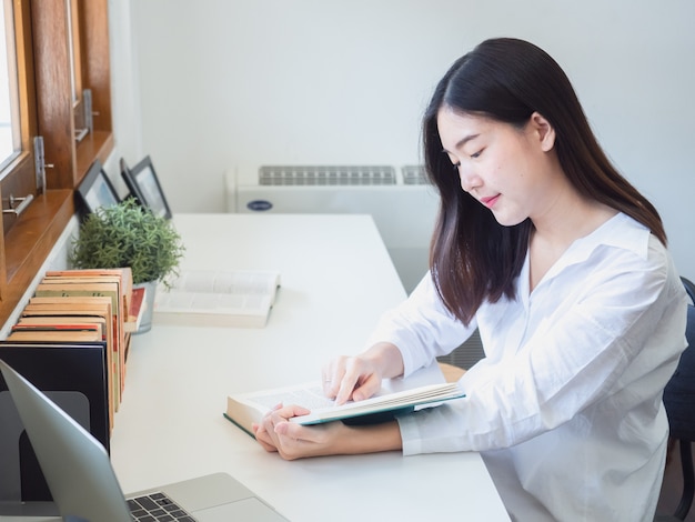 Premium Photo | Asian woman reading book in working room
