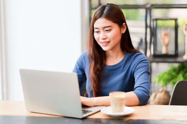 Premium Photo | Asian woman using computer laptop and drink coffee work ...