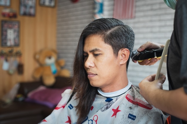 cutting long hair with electric clippers