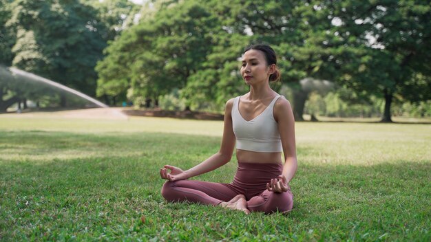 Premium Photo Asian Young Woman Sitting On The Grass In The Lotus