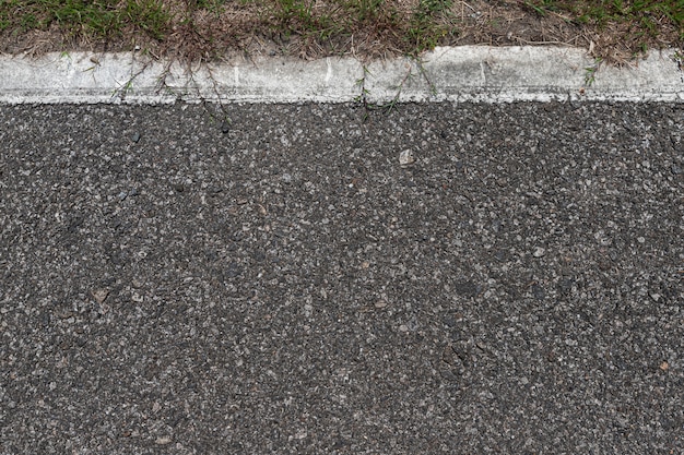 Asphalt road with stripes and green grass texture background,empty copy space. Premium Photo