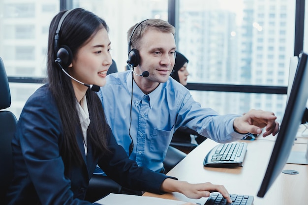 Premium Photo | Assistant supervising the call center staff in the ...