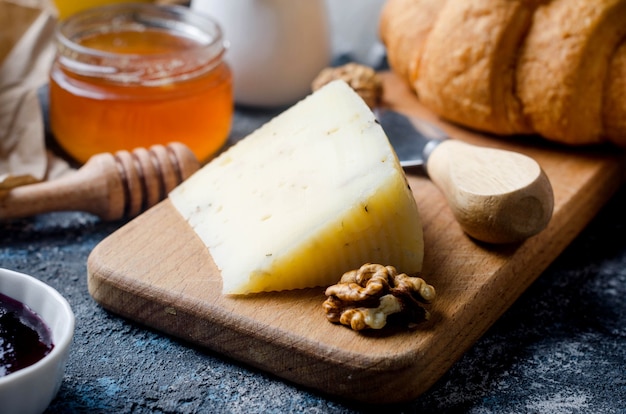 Premium Photo Assorted Homemade Pieces Cheese With Honey Fruits