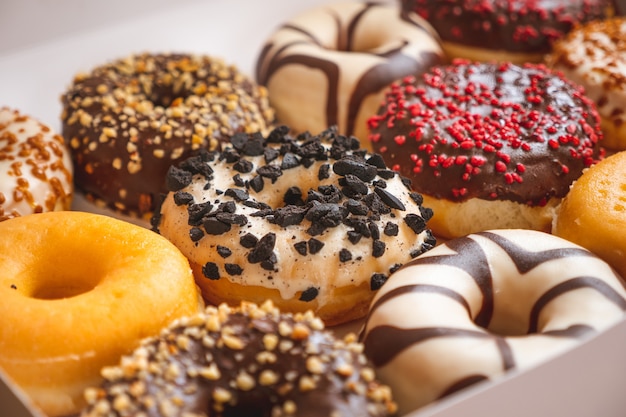 Premium Photo | Assortment of donuts of different flavors in a box