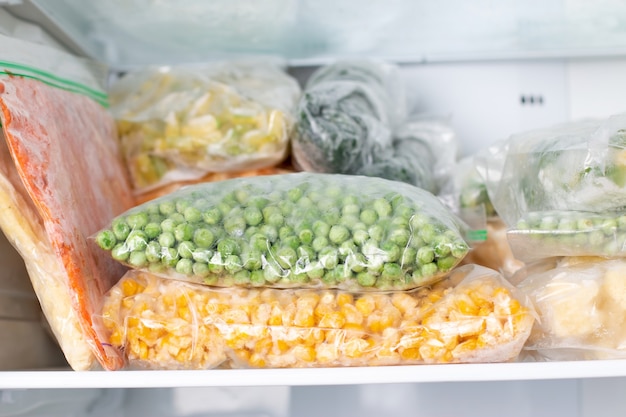 Premium Photo | Assortment of frozenvegetables in home fridge. frozen ...