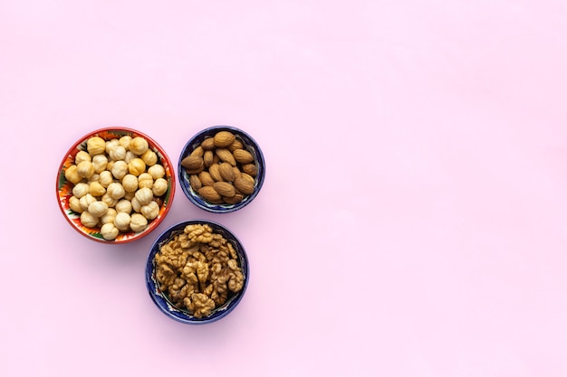 Assortment mix of nuts, hazelnuts, almonds, walnuts in bowls. flat lay, top view Premium Photo
