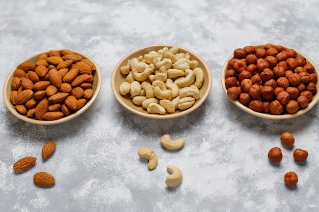 Free Photo | Assortment of nuts in ceramic plates. cashew, hazelnuts ...