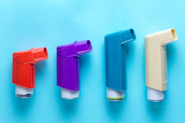 Premium Photo | Asthma inhalers on blue