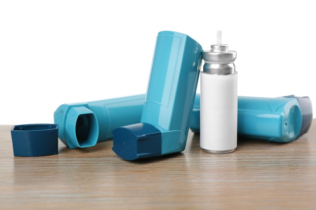 Premium Photo | Asthma inhalers on wooden table