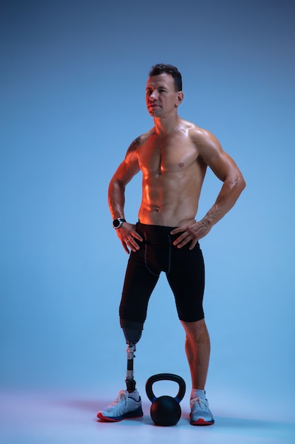 Free Photo | Athlete with disabilities or amputee isolated on blue studio