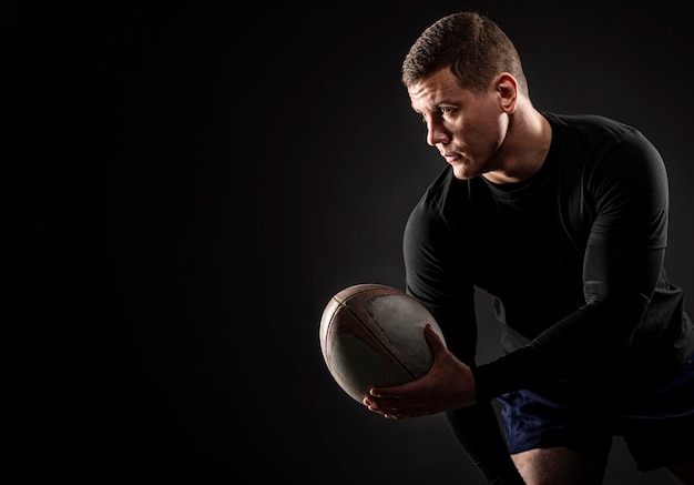 Premium Photo | Athletic Handsome Male Rugby Player Holding Ball With ...