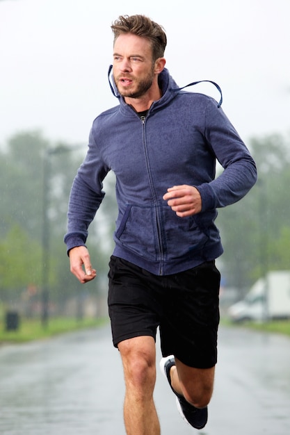 Premium Photo | Athletic older man training outside in rain