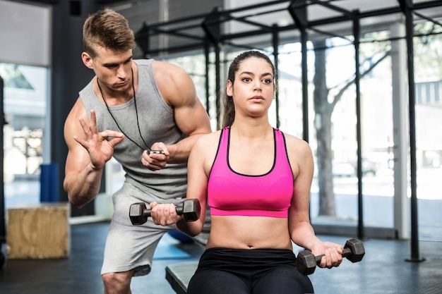 Athletic Woman Working Out Helped By Trainer Man At Gym Premium Photo