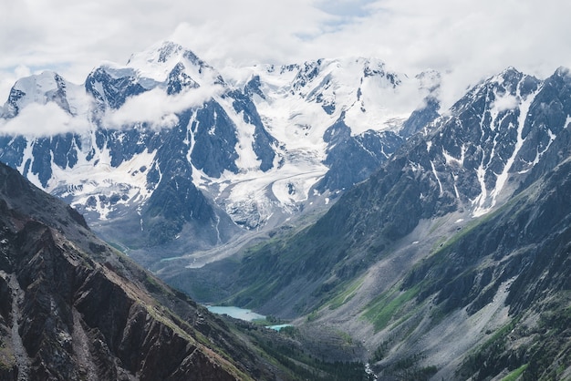 Premium Photo Atmospheric Alpine Landscape With Massive Hanging Glacier On Giant Rocks And Valley With Mountain Lakes