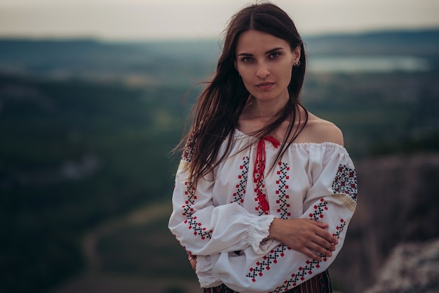 https://image.freepik.com/free-photo/atractive-woman-traditional-romanian-costume-mountain-green-blurred-background_135932-1979.jpg