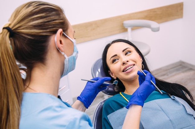 Premium Photo | Attractive brunette girl at the dentist consultation