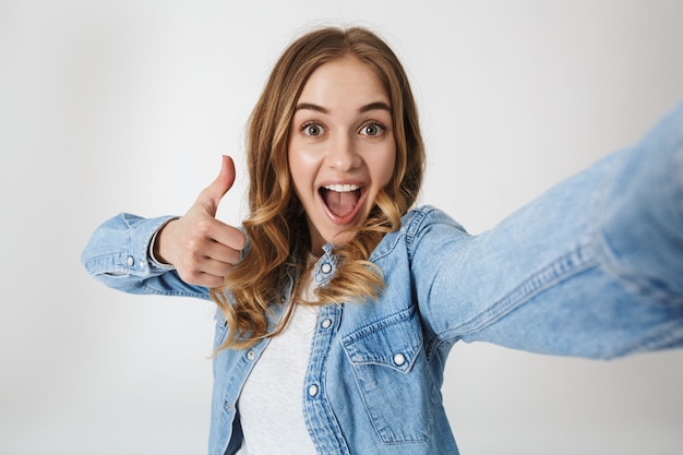 Premium Photo | Attractive excited young girl standing isolated over ...