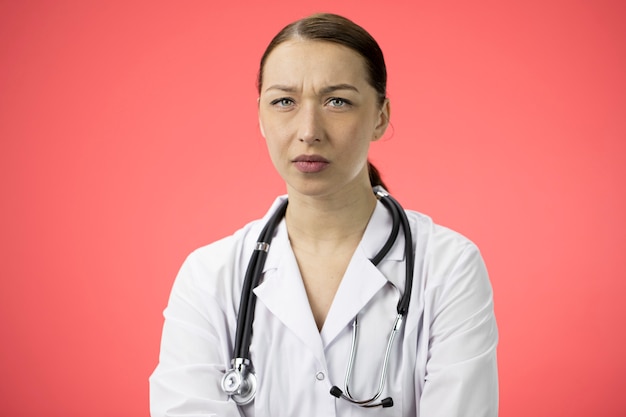 Premium Photo | Attractive female doctor looks unhappy, tired and ...