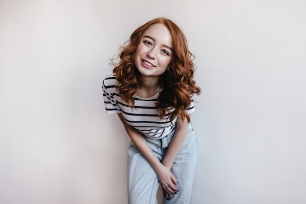 Free Photo Attractive Girl In Vintage Jeans Posing With Smile Upon Her Face Portrait Of Ginger Female Model In Trendy Spring Attire