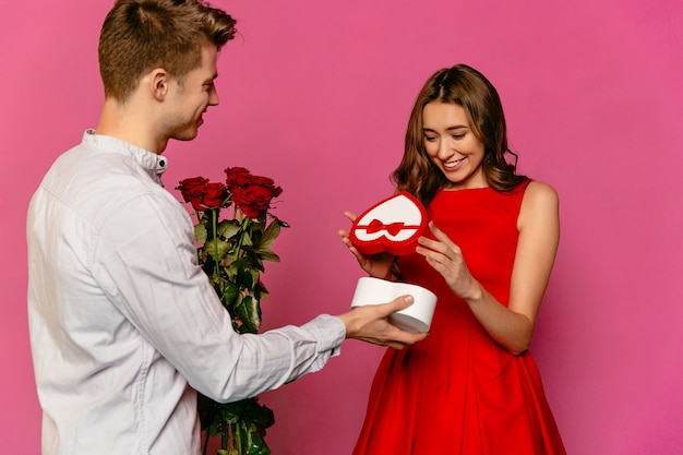Attractive guy making gift making gift in the form of heart