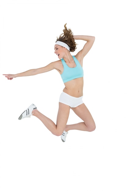 Premium Photo Attractive Sporty Woman Jumping While Pointing