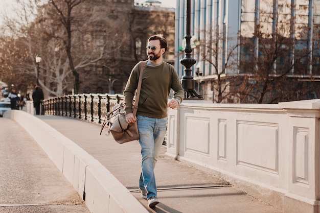 Free Photo | Attractive stylish hipster man walking in city street with ...