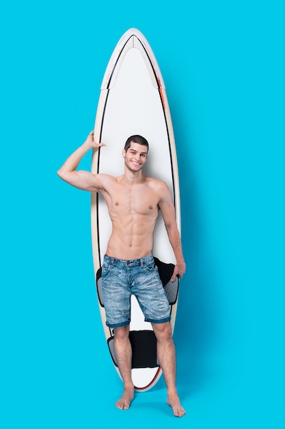 Free Photo | Attractive surfer holding a surfboard